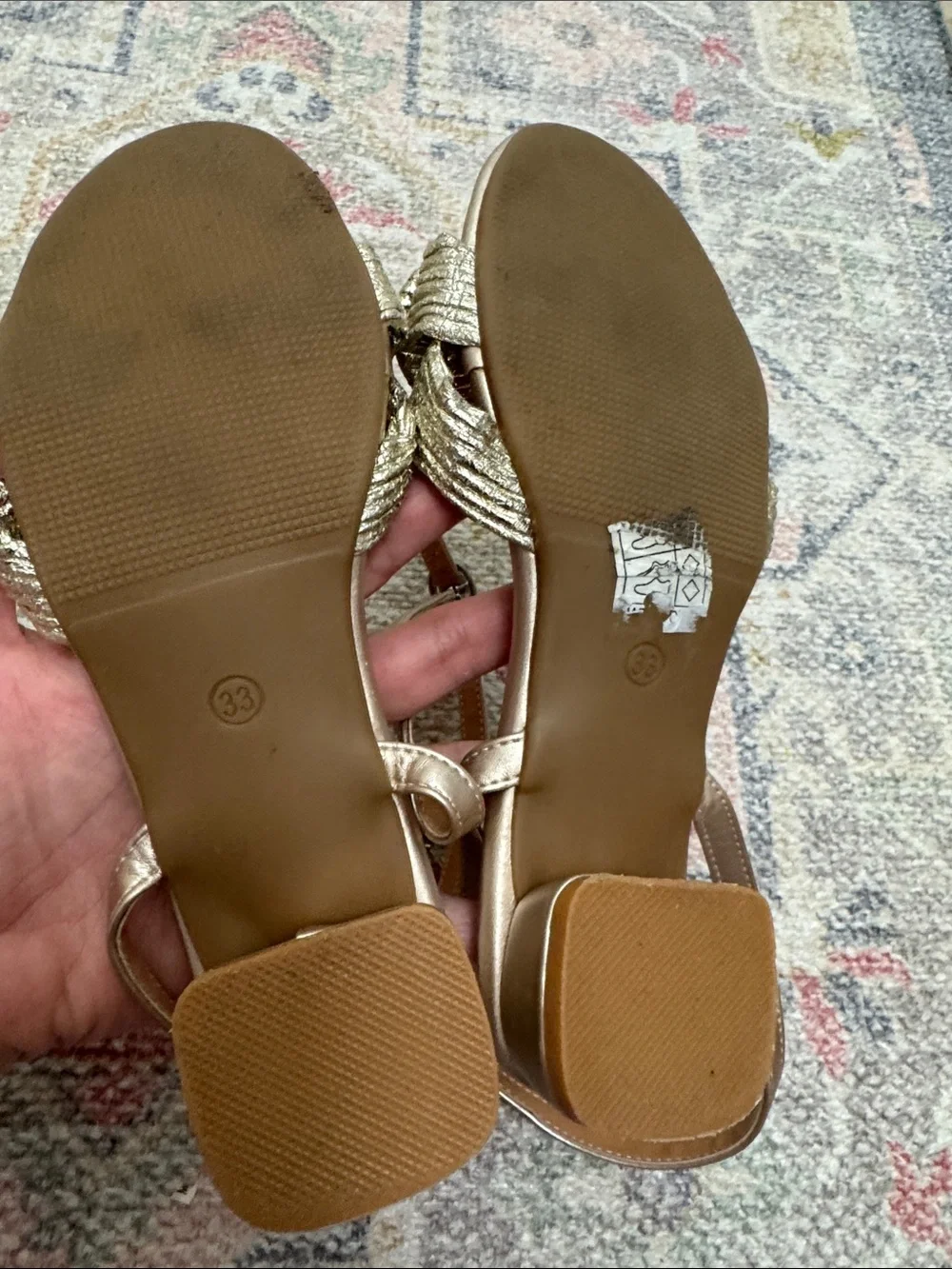 Girls gold ankle wrap sandals with bow.